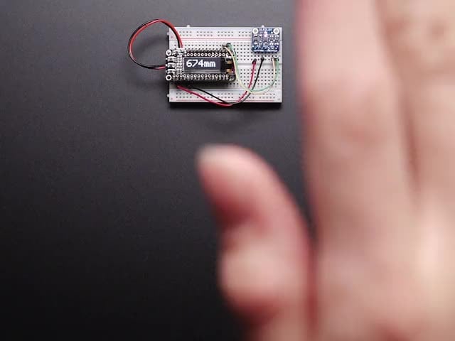 Adafruit VL53L0X Time of Flight Distance Sensor - ~30 to 1000mm - Video of a white hand hovering over a Adafruit VL53L0X Time of Flight Distance Sensor that's connected to a white breadboard reading the range of motion of the white hand. 