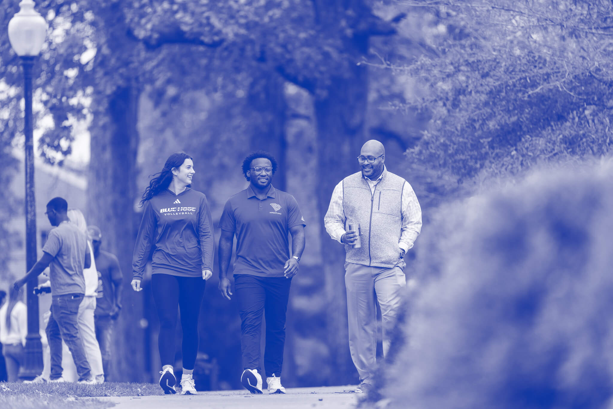 Professor, Dr. Will Harris and two students walk on Presbyterian College campus