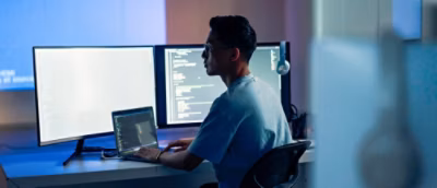 A man looking at the screen and typing something from keyboard