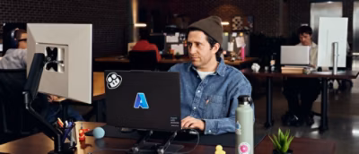 A man looking at the screen and working in the office environment