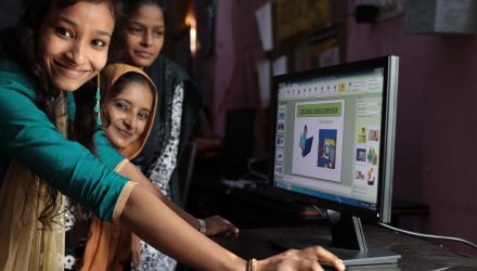Participants in the Young Women Leadership Program explain software to each other